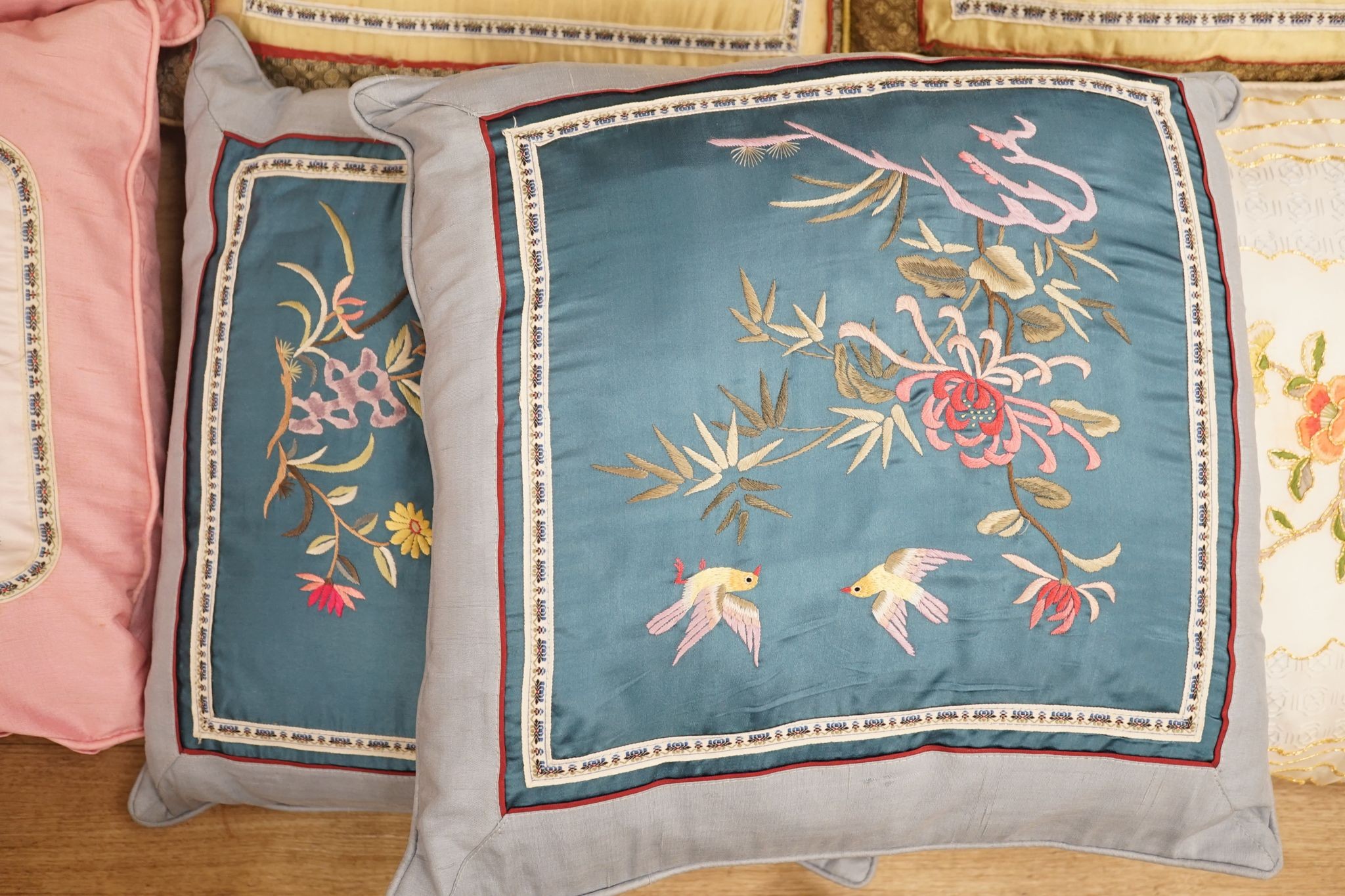Three pairs of Chinese silk embroidered cushions and a cushion